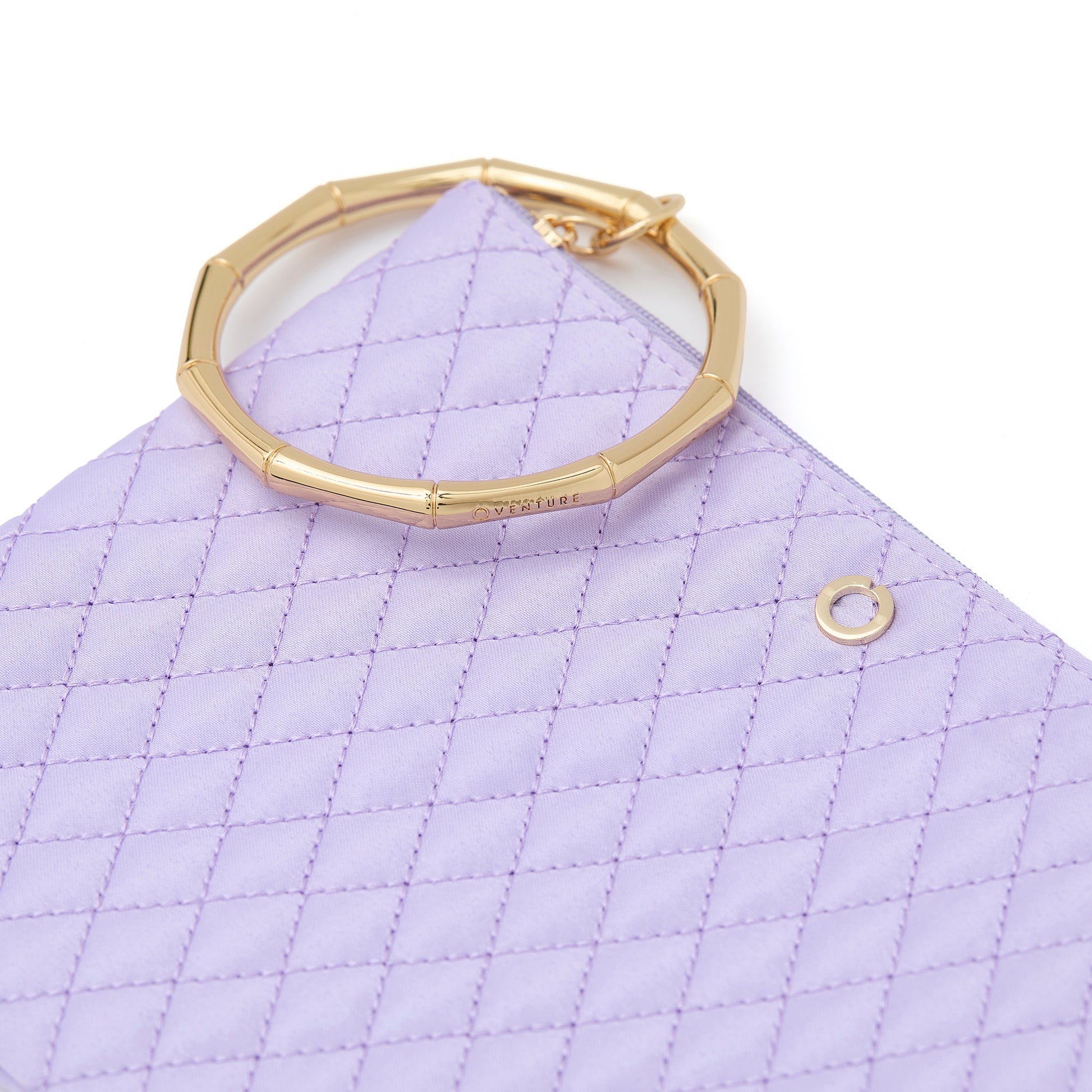 Quilted lavender bracelet bag for hands-free style.