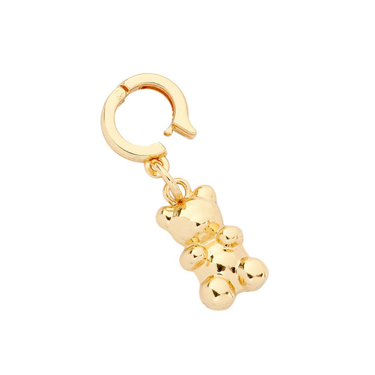 A gold-colored teddy bear charm with a huggie-style closure, designed for use with jewelry such as bracelets or necklaces.
