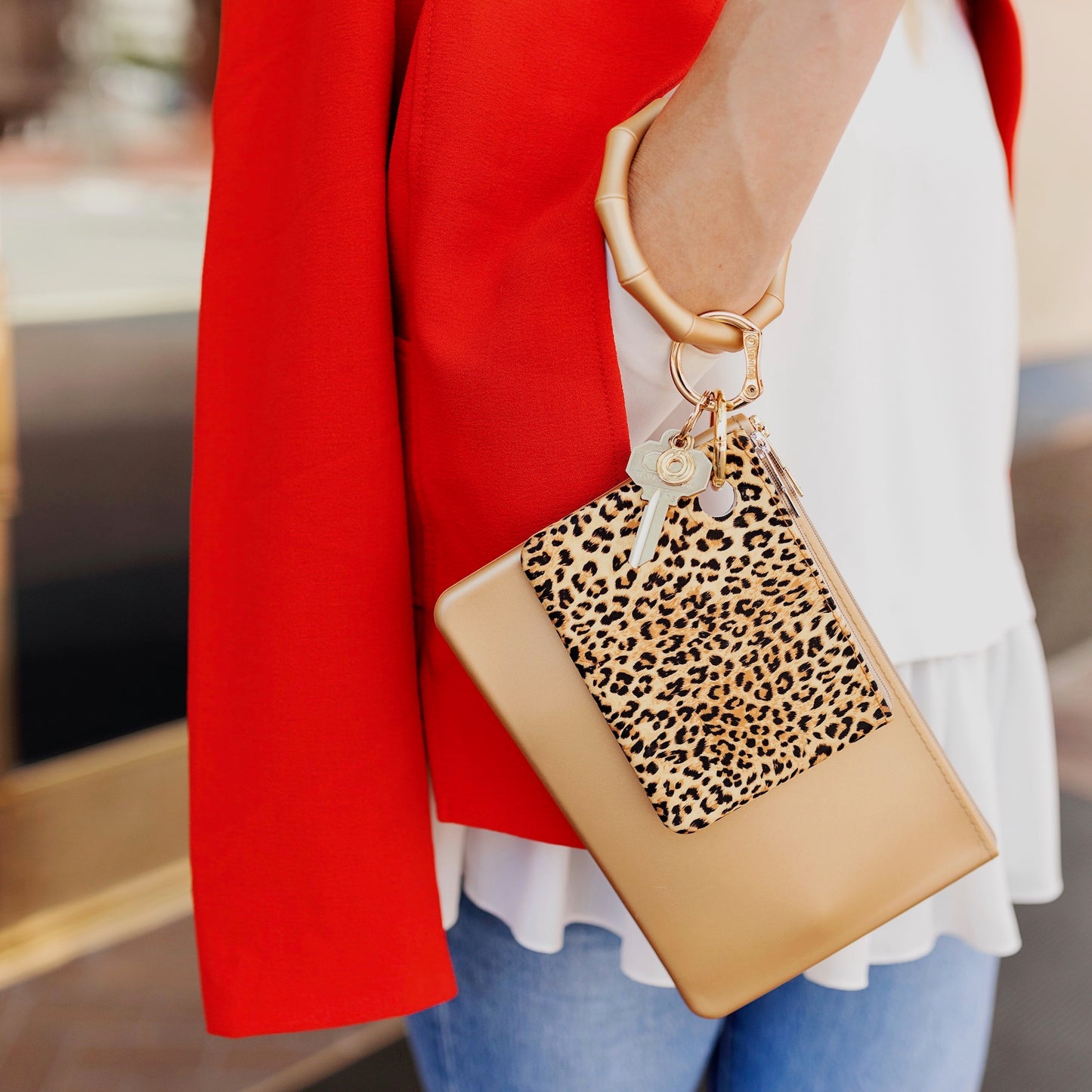 Small cheetah print mini pouch for organization shown attached to gold bamboo bracelet keyring and large pouch.