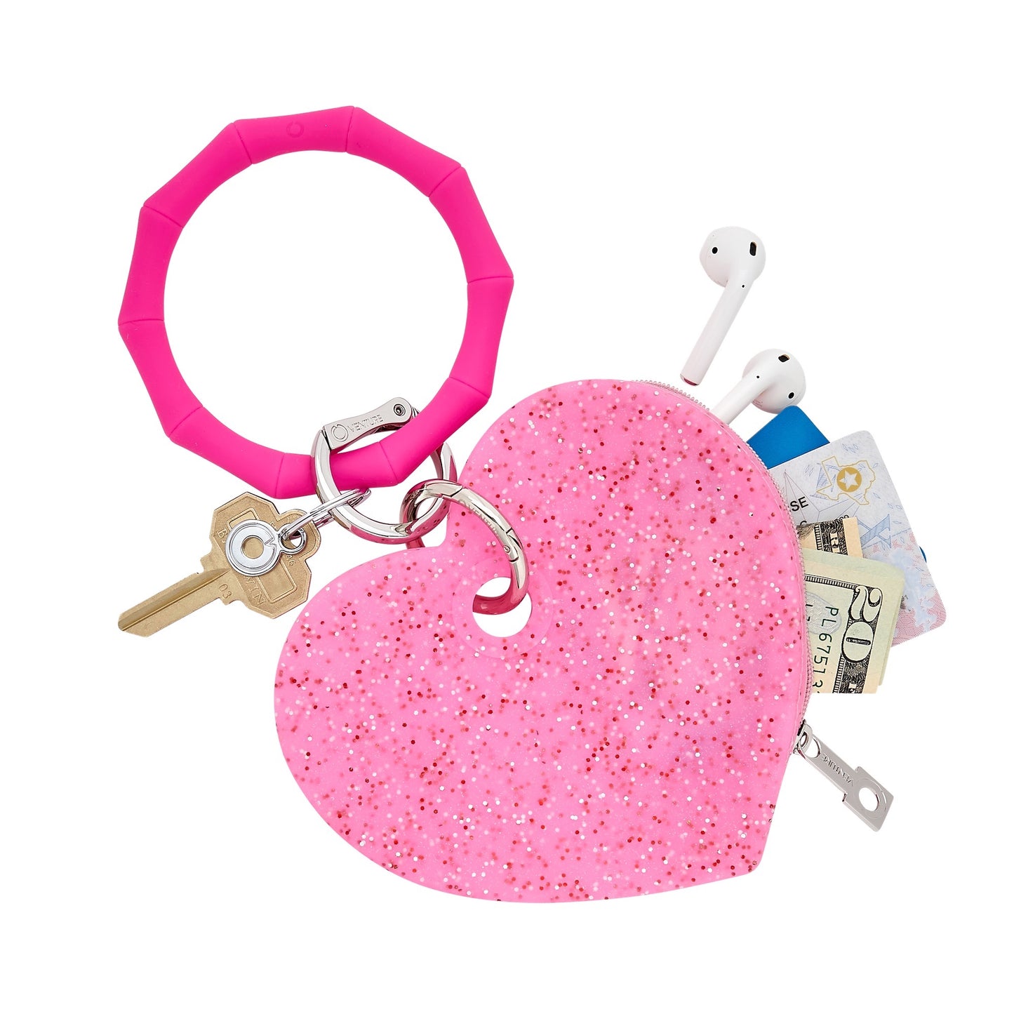Oventure Tickled Pink Confetti silicone heart pouch attached to a Tickled Pink Big O® Key Ring, carrying cash, cards, earbuds, and keys.