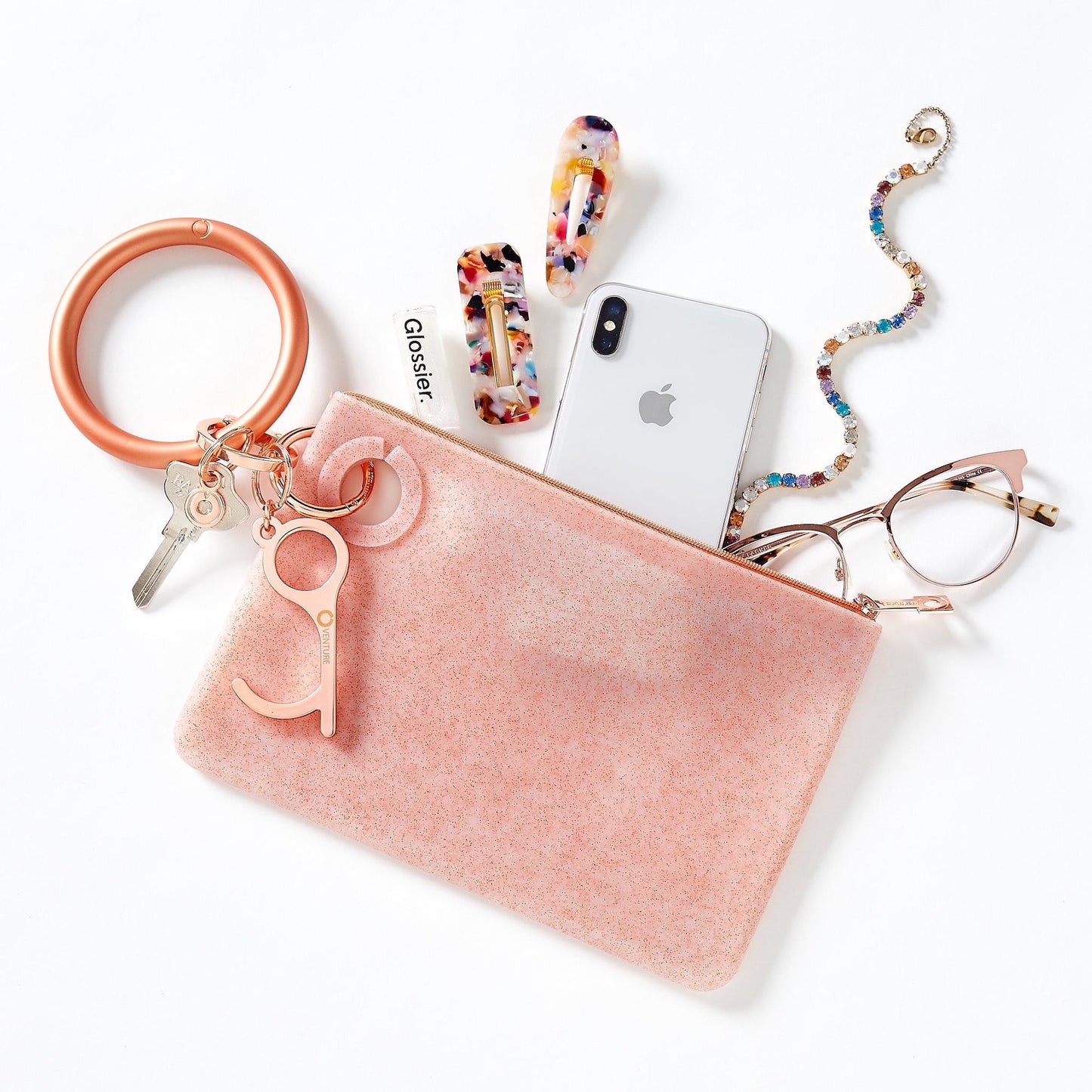 Oventure Large silicone pouch holding phone, glasses, lip gloss and hair clips. This wallet is attached to a keychain to become a wallet wristlet.