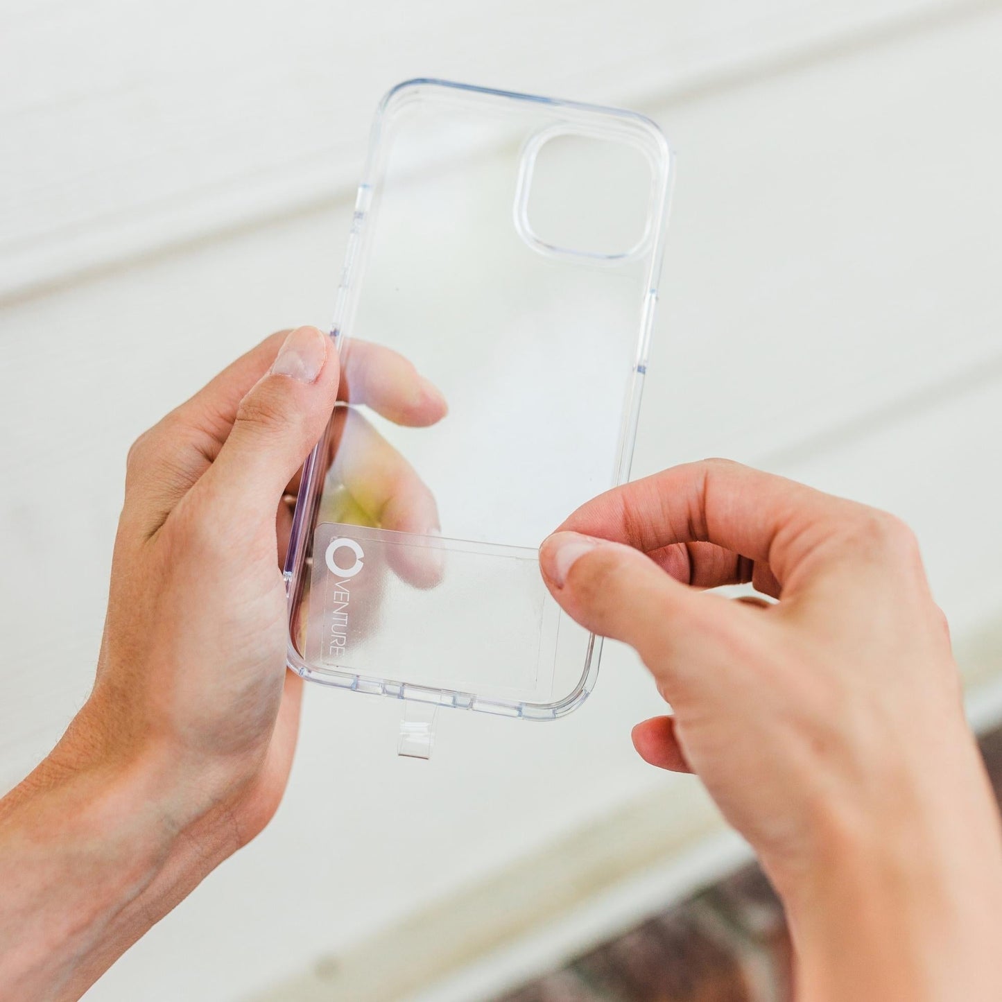 Oventure Hook Me Up Phone Attachment being placed inside phone case