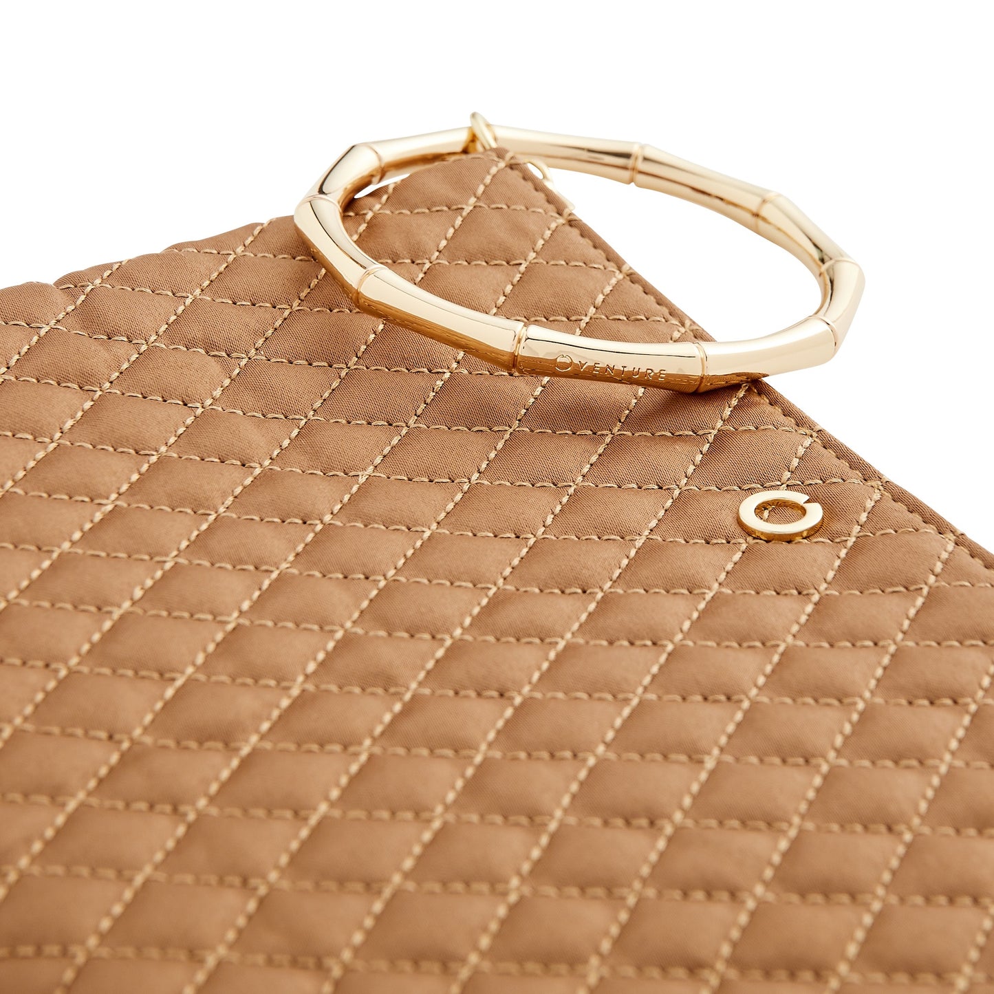A versatile caramel clutch bag with bracelet handle