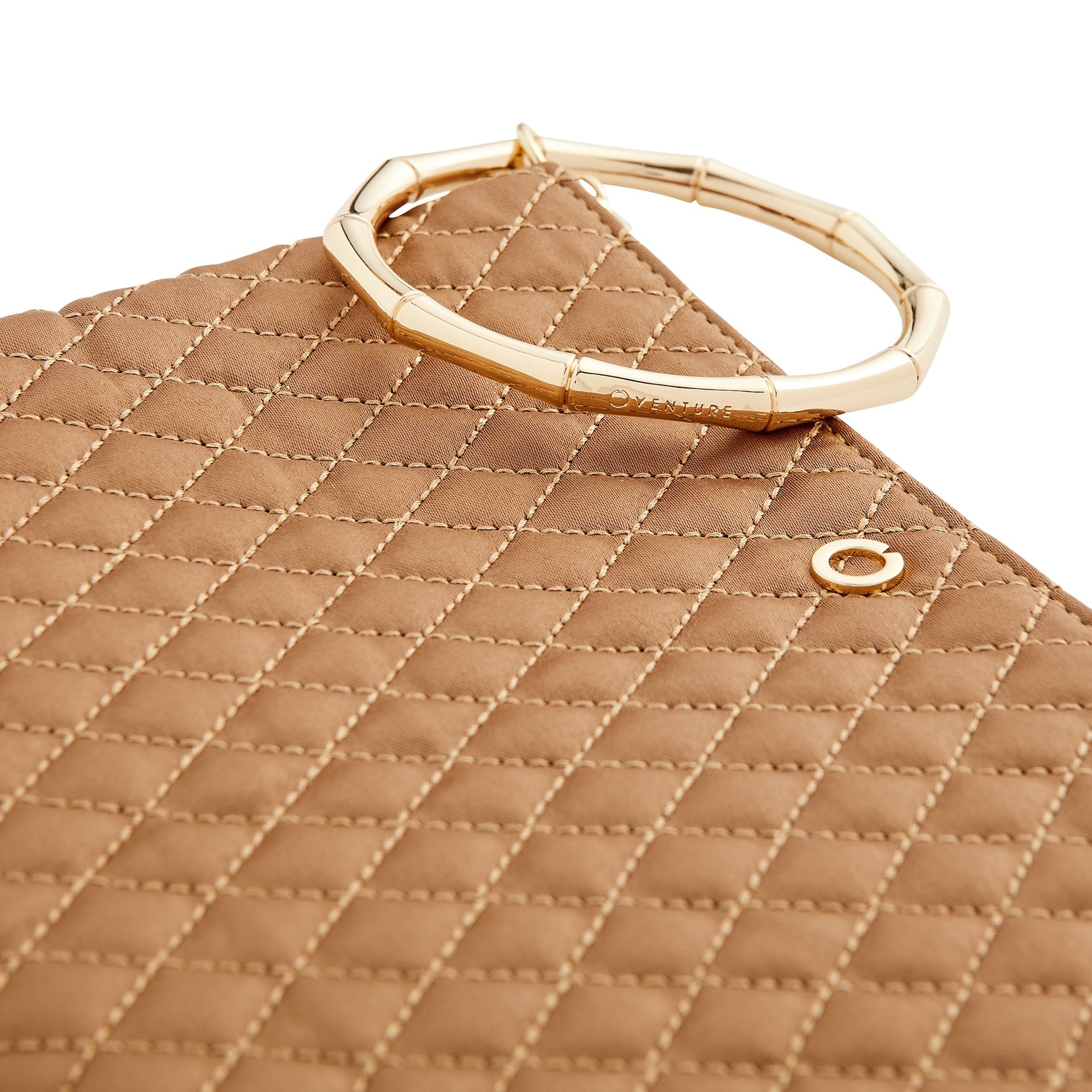 A versatile caramel clutch bag with bracelet handle