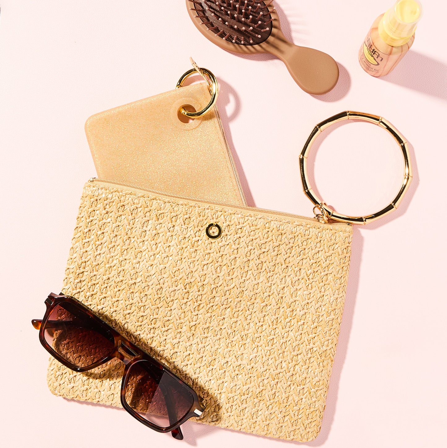 Stylish natural raffia bracelet bag with beach accessories