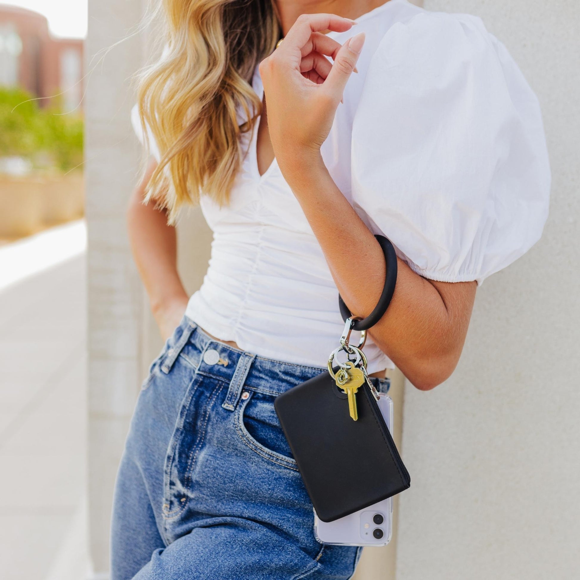 Sleek black Mini Pouch for cards and cash shown attached to a key ring bracelet.