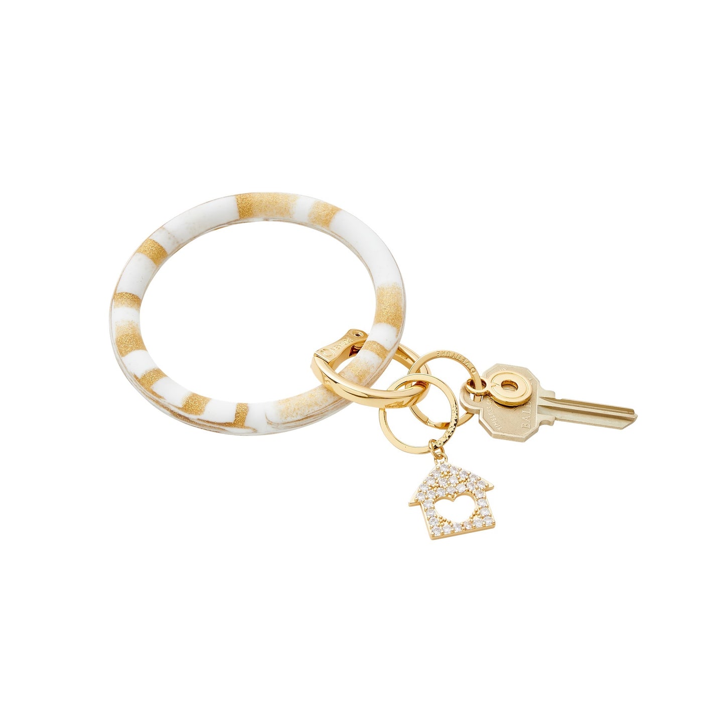 Big O Key Ring in gold and white swirled marble with charm attached. Attached is the home is where the heart is charm in gold.