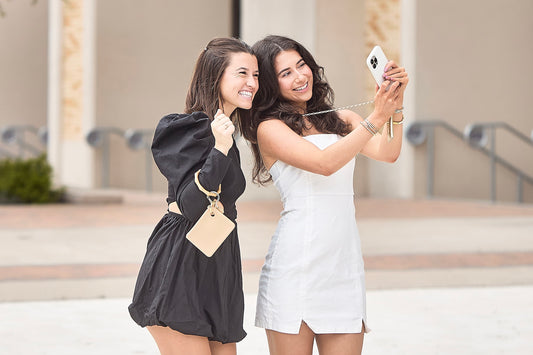 Pouch wristlet and Phone crossbody chain shown on campus