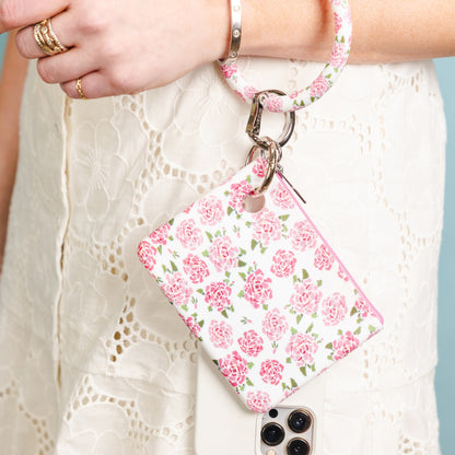 Image of essential Mini Pouch Wristlet with Phone Holder in pink floral.