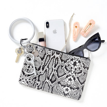 Solid Quicksilver Pearlized - Silicone Big O Key Ring by Oventure shown attached to the Large Silicone Pouch in tuxedo snakeskin print.  Pouch contains sunglasses, iPhone, and lip gloss. 