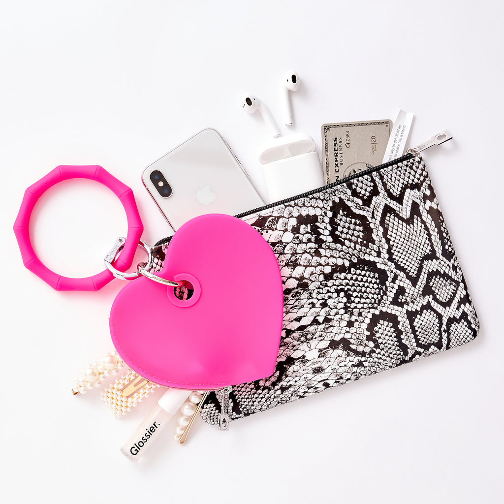 Tickled Pink - Silicone Heart Pouch - Oventure shown layered on the large silicone pouch in tuxedo snakeskin