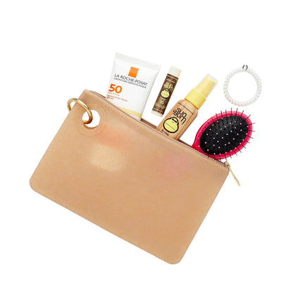 Large gold confetti silicone pouch filled with essentials like hair brush, sunscreen and chapstick by Oventure