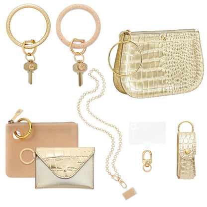 Gold Hands-Free Wardrobe - Oventure which includes two gold Big O Key Rings, gold wallets, a gold lipstick holder, a gold crossbody chain and a bracelet bag