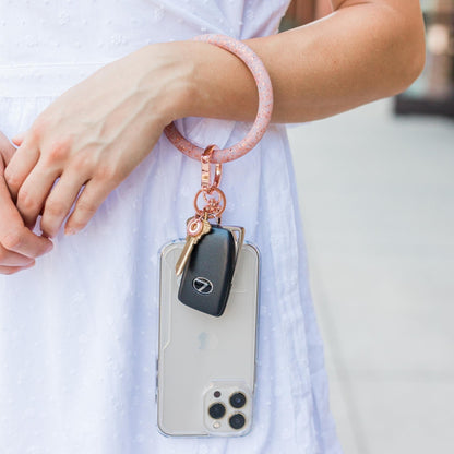 A hands-free rose gold phone tab connector.