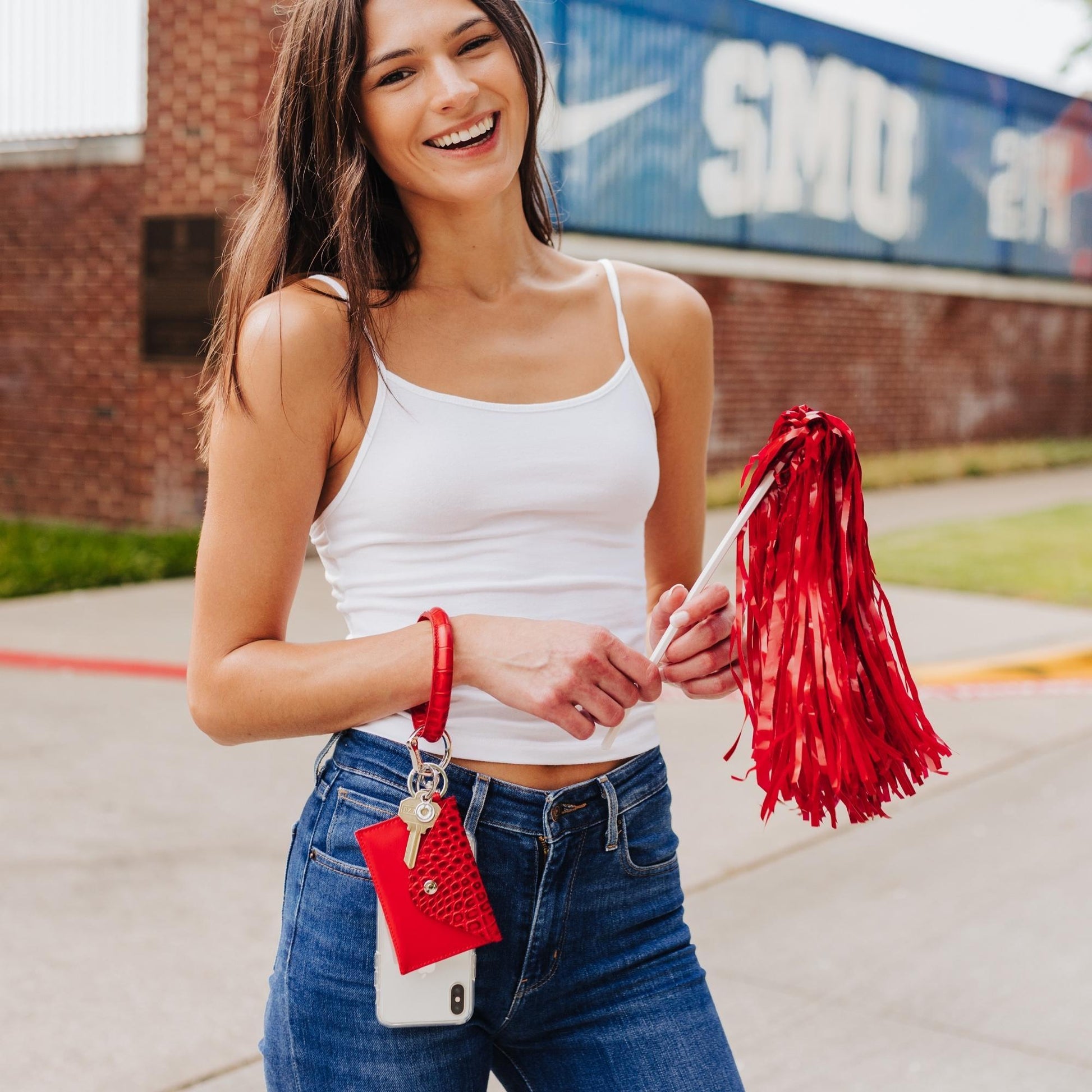 3-in-1 Cherry On Top Leather Mini Envelope Set - Oventure shown in game day style with a pom pom and a phone connector. All connected by the life hub Big O Key Ring.