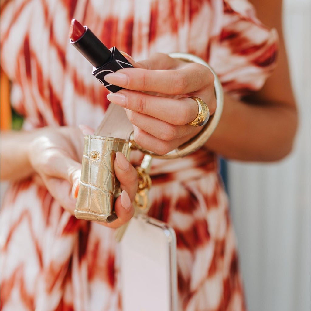 Gold Hands-Free Wardrobe - Oventure featuring the lipstick holder in gold embossed croc attached to the Big O key ring.