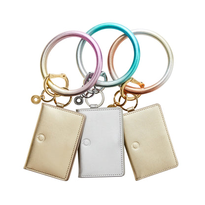 All three ombre leather big o keyring in a row with leather id cases attached in gold and silver by Oventure