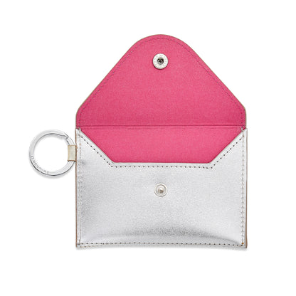 Leather mini envelope with gold flap and back with silver front with silver hardware. Shown with the flap open with hot pink lining