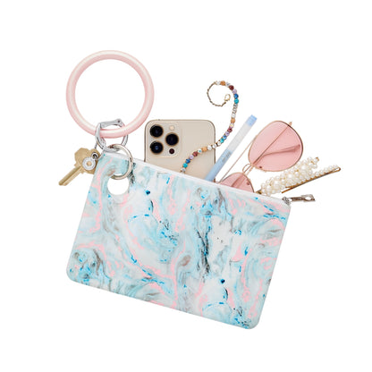 Baby blue, light pink, off white marble swirl print large silicone pouch attached to a Rose silicone big o key ring with phone and accessories