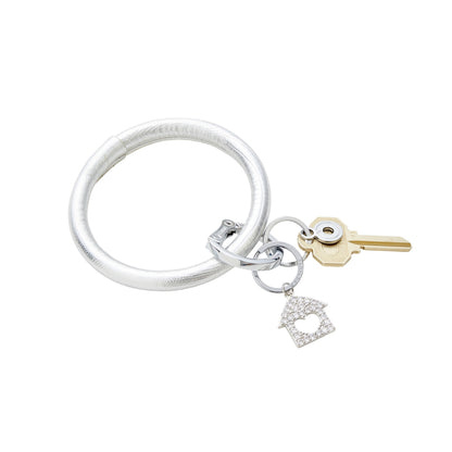 silver leather big o key ring with home is where the heart is charm attached.