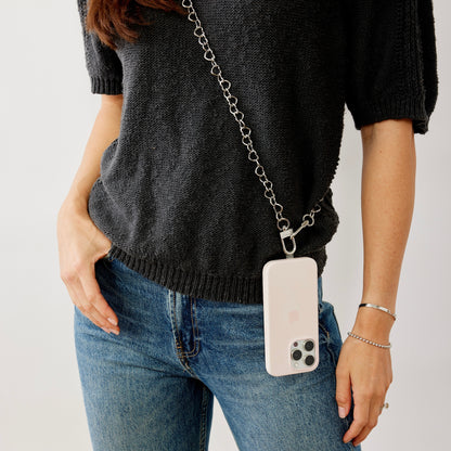 A Chic phone crossbody with silver heart chain.