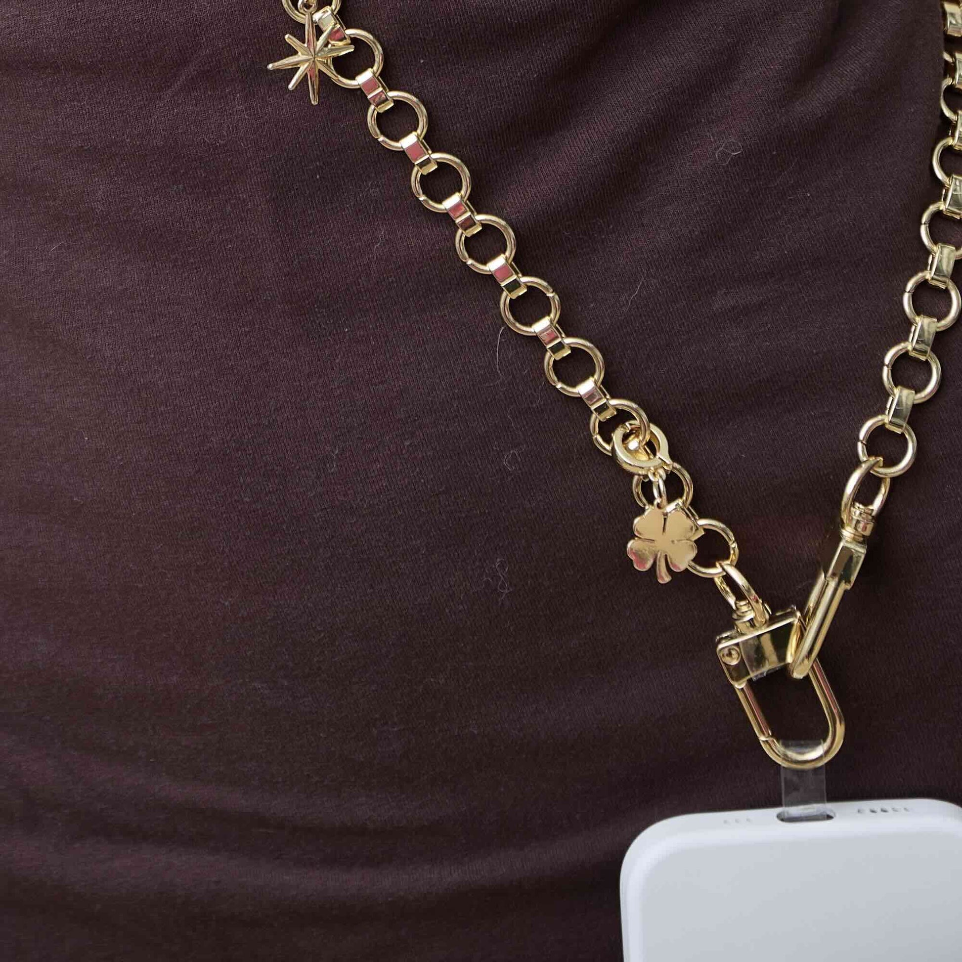 Gold chain strap with clasp and gold charms attached