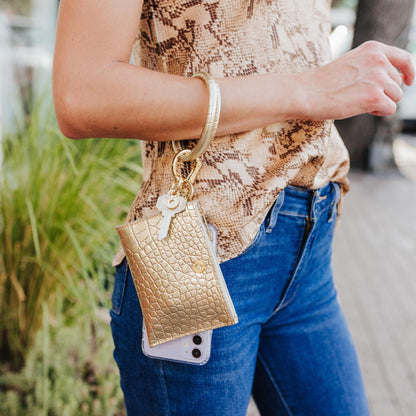  Gold Wallet wristlet shown over the arm with bracelet keyring.