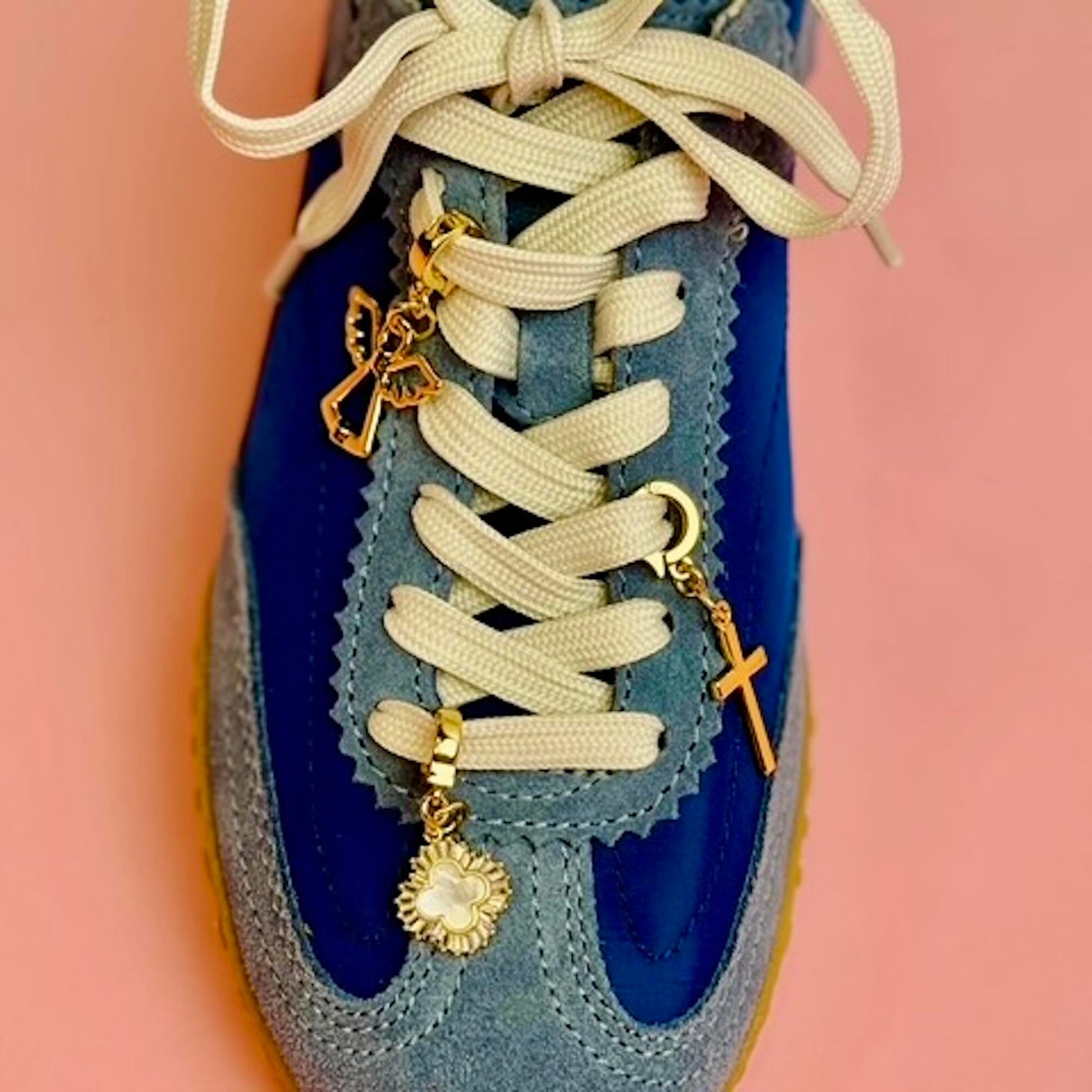 Angel, Mother of Pearl and Cross gold charms on blue tennis shoes laces