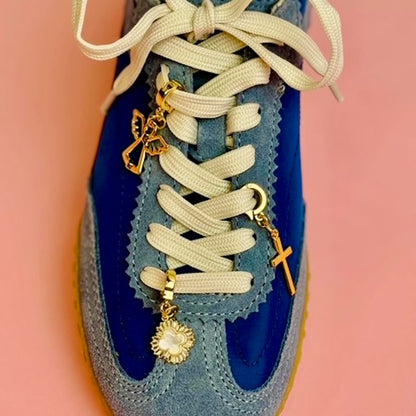 Angel, Mother of Pearl and Cross gold charms on blue tennis shoes laces