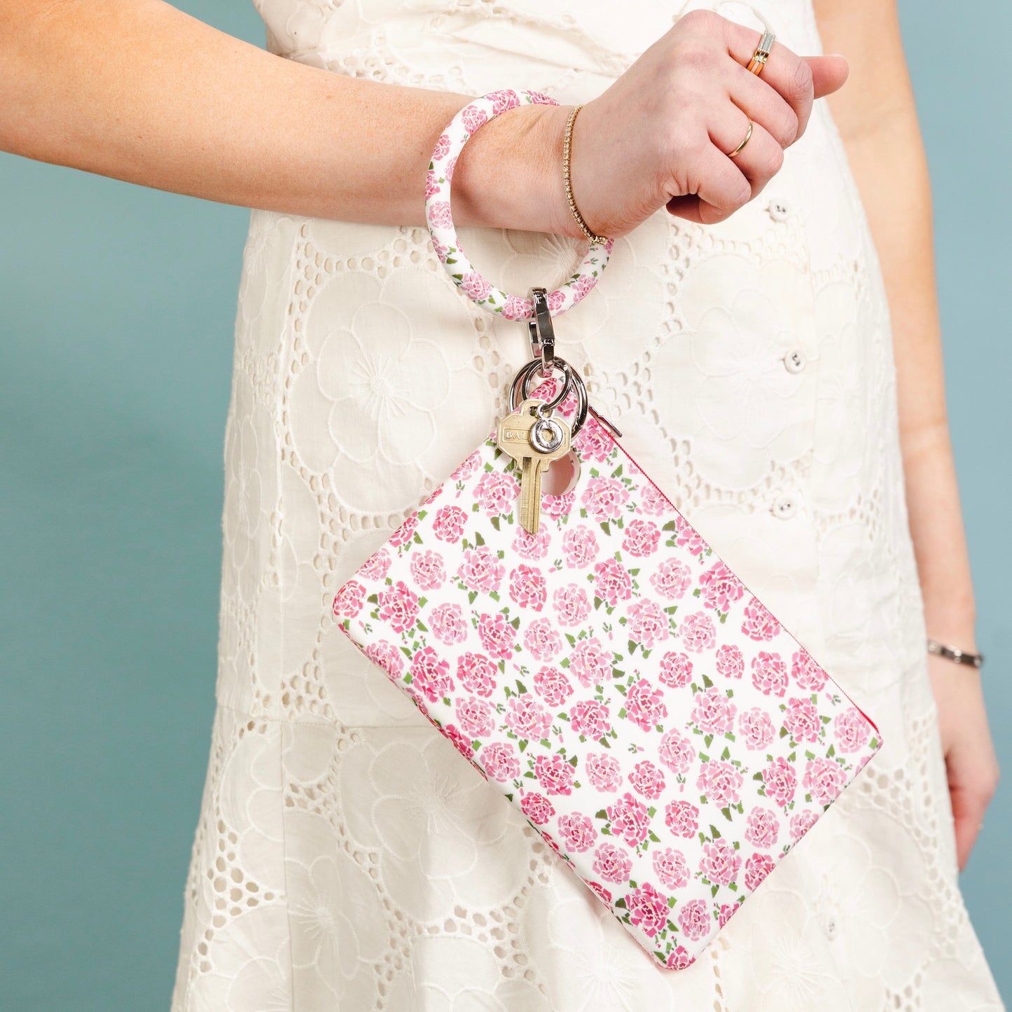 Large Pouch in Fifty States Pink Silicone, water-resistant, shown hooked to a bracelet keychain.