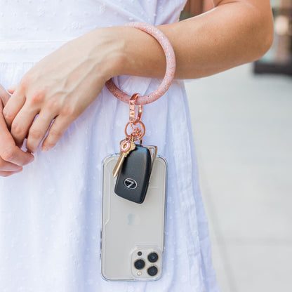 Rose Gold Big O Key Ring and Phone Connector Oventure shown on wrist with phone attached