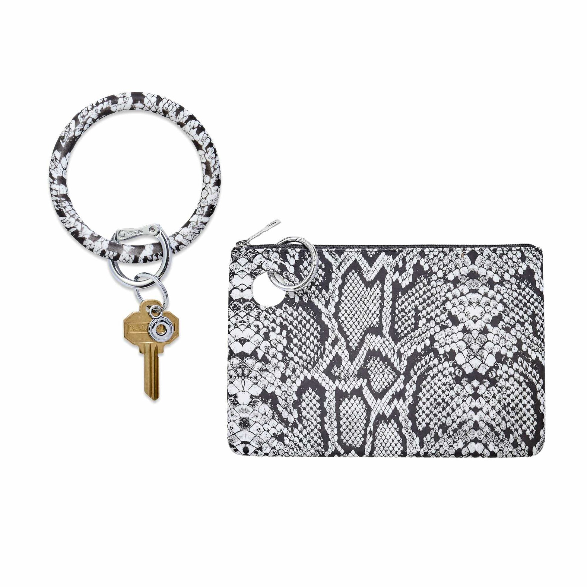 Black and white snakeskin-print silicone Big O® Key Ring with gold house key, paired with a matching water-resistant silicone pouch wristlet, shown on a white background.
