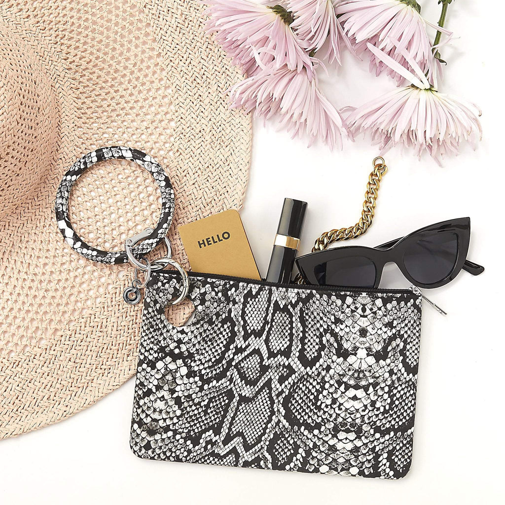 Black and white snakeskin print silicone big O key ring with silver locking clasp. Attached to large silicone tuxedo snakeskin pouch with sun hat and accessories 